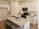 Modern kitchen with white cabinets, granite countertops, stainless steel appliances and island with seating at 2690 Ne Almand Ln, Conyers, GA 30013