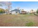 The backyard features a lawn, fire pit, covered deck, and view of the home at 500 Katherines Cv, Mcdonough, GA 30253
