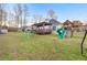 This spacious fenced backyard includes a lawn, playset, and covered deck area at 500 Katherines Cv, Mcdonough, GA 30253