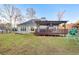 The backyard features a covered deck, playset, a grassy lawn, and exterior view of the house at 500 Katherines Cv, Mcdonough, GA 30253