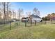 The fenced backyard features a lawn, playset, covered deck, and view of the home at 500 Katherines Cv, Mcdonough, GA 30253