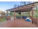 Outdoor covered deck features a ceiling fan, TV, dining table, outdoor grill, and picnic table at 500 Katherines Cv, Mcdonough, GA 30253