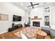 Cozy living room with fireplace, high ceilings, wood floors, and large windows providing ample natural light at 500 Katherines Cv, Mcdonough, GA 30253