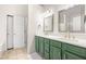 Ensuite main bathroom with double sinks, granite countertops, and green cabinets at 500 Katherines Cv, Mcdonough, GA 30253