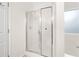 Bathroom featuring a shower with glass doors and a frosted window at 500 Katherines Cv, Mcdonough, GA 30253