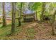A charming house with a deck nestles among trees, offering a serene and private backyard setting at 5307 Jay Nw Way, Lilburn, GA 30047