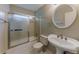 The bathroom has tile flooring, shower with glass doors, and a decorative framed mirror at 5307 Jay Nw Way, Lilburn, GA 30047