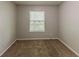 Cozy bedroom featuring neutral paint, carpet flooring, and a window with peaceful views at 5307 Jay Nw Way, Lilburn, GA 30047
