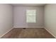 Light-filled bedroom features neutral paint, cozy carpet, and serene window views at 5307 Jay Nw Way, Lilburn, GA 30047