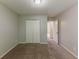 This bedroom features neutral carpet and walls, plus a closet for essential storage at 5307 Jay Nw Way, Lilburn, GA 30047