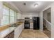 Functional kitchen with tile flooring, a full appliance suite, and ample natural light at 5307 Jay Nw Way, Lilburn, GA 30047