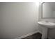 Bathroom with pedestal sink and hardwood floors at 5829 Taka Ln, Lithonia, GA 30038
