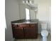 Bathroom featuring granite vanity, large mirror, and ample lighting, with a view of the toilet at 5829 Taka Ln, Lithonia, GA 30038
