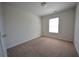 Comfortable bedroom featuring neutral carpeting, a window with natural light, and fresh paint at 5829 Taka Ln, Lithonia, GA 30038