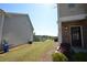 A townhome featuring brick siding, a side door, and green lawn and landscaping at 5829 Taka Ln, Lithonia, GA 30038