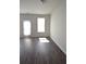Living room with a sliding door, hardwood floors, and neutral walls at 5829 Taka Ln, Lithonia, GA 30038