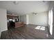 Open concept living room with hardwood floors and a view into the kitchen at 5829 Taka Ln, Lithonia, GA 30038
