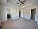 Bright main bedroom with ensuite bath, walk-in closet, neutral paint and carpet with a ceiling fan at 5829 Taka Ln, Lithonia, GA 30038
