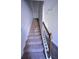 Carpeted staircase with decorative wood and iron railing leading to the upper level of the home at 5829 Taka Ln, Lithonia, GA 30038
