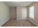 Carpeted bedroom features a window and door, offering comfort and convenience at 6205 Leverett Dr, Lithonia, GA 30038