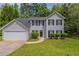Charming two-story home featuring a well-manicured lawn and attached two-car garage at 6205 Leverett Dr, Lithonia, GA 30038