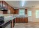 Well-lit kitchen boasts wooden cabinets, modern appliances, and a convenient door to the backyard at 6205 Leverett Dr, Lithonia, GA 30038