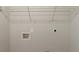Simple laundry room with connections and a wire rack for storage at 6205 Leverett Dr, Lithonia, GA 30038