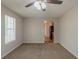 Cozy living room featuring plush carpet, a ceiling fan, and access to the kitchen at 6205 Leverett Dr, Lithonia, GA 30038