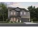 Charming two-story home featuring stone accents, gray siding, manicured landscaping, and an attached two-car garage at 7630 Homer Dr, Cumming, GA 30028