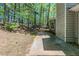 The backyard features a small concrete patio, complemented by mature trees for shade and privacy at 1665 Dunbarton Dr, Lithonia, GA 30058
