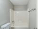 Clean bathroom features a shower-tub combo with a white shower and a toilet at 1665 Dunbarton Dr, Lithonia, GA 30058