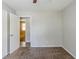 Bedroom with neutral walls and carpet flooring, leading to additional room, offering a calming space at 1665 Dunbarton Dr, Lithonia, GA 30058