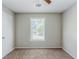 A bright bedroom with a window, neutral walls and ceiling fan at 1665 Dunbarton Dr, Lithonia, GA 30058