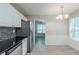 Open kitchen showcasing stainless steel refrigerator, tile backsplash, and access to dining area at 1665 Dunbarton Dr, Lithonia, GA 30058