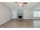 Spacious living room features hardwood floors, a fireplace and a ceiling fan at 1665 Dunbarton Dr, Lithonia, GA 30058