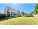 Large backyard featuring lush green grass, a covered patio and plenty of room for outdoor activities at 1835 Wellston Dr, Lawrenceville, GA 30043