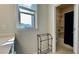 Bathroom with neutral tile flooring, a large window, and shower/tub combo, offering a clean and bright space at 1835 Wellston Dr, Lawrenceville, GA 30043
