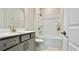 Bathroom with a shower-tub combo, grey vanity, toilet, and tile flooring at 1835 Wellston Dr, Lawrenceville, GA 30043
