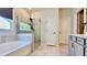 Modern bathroom with a shower with glass surround, soaking tub, tile flooring, and gray vanity at 1835 Wellston Dr, Lawrenceville, GA 30043