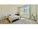 Sunlit bedroom featuring a large window, carpet flooring, and modern decor, offering a cozy retreat at 1835 Wellston Dr, Lawrenceville, GA 30043