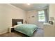 Cozy bedroom featuring a comfortable bed, soft carpet, and a bright window with natural light at 1835 Wellston Dr, Lawrenceville, GA 30043