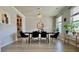 Elegant dining room with modern light fixture, large windows, and stylish decor at 1835 Wellston Dr, Lawrenceville, GA 30043