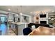 Open concept living space with a kitchen island, dining table, and staircase at 1835 Wellston Dr, Lawrenceville, GA 30043