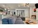 Bright open-concept living room flows into a kitchen with stainless steel appliances and modern light fixtures at 1835 Wellston Dr, Lawrenceville, GA 30043