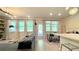 Sunlit living room with large windows, dining area, and open layout, providing a welcoming and airy space at 1835 Wellston Dr, Lawrenceville, GA 30043