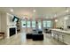 Spacious living room features a fireplace, large windows, and an open layout with modern light fixtures at 1835 Wellston Dr, Lawrenceville, GA 30043
