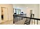 Bright loft area with a view to the home office and staircase with classic black iron spindles at 1835 Wellston Dr, Lawrenceville, GA 30043