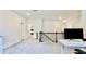 Spacious loft with neutral carpeting and a modern black railing overlooking the stairs, offering flexible living space at 1835 Wellston Dr, Lawrenceville, GA 30043