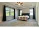 Spacious main bedroom with tray ceiling, a ceiling fan, and large windows at 1835 Wellston Dr, Lawrenceville, GA 30043
