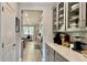 View of a modern pantry with glass-front cabinets and ample storage space at 1835 Wellston Dr, Lawrenceville, GA 30043